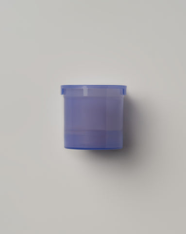 Skin Reset Serum purple refill pod displayed against a minimalist light gray background