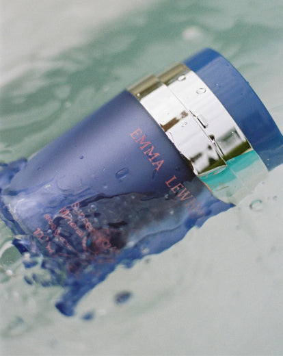 Purple and silver product partially submerged in water.